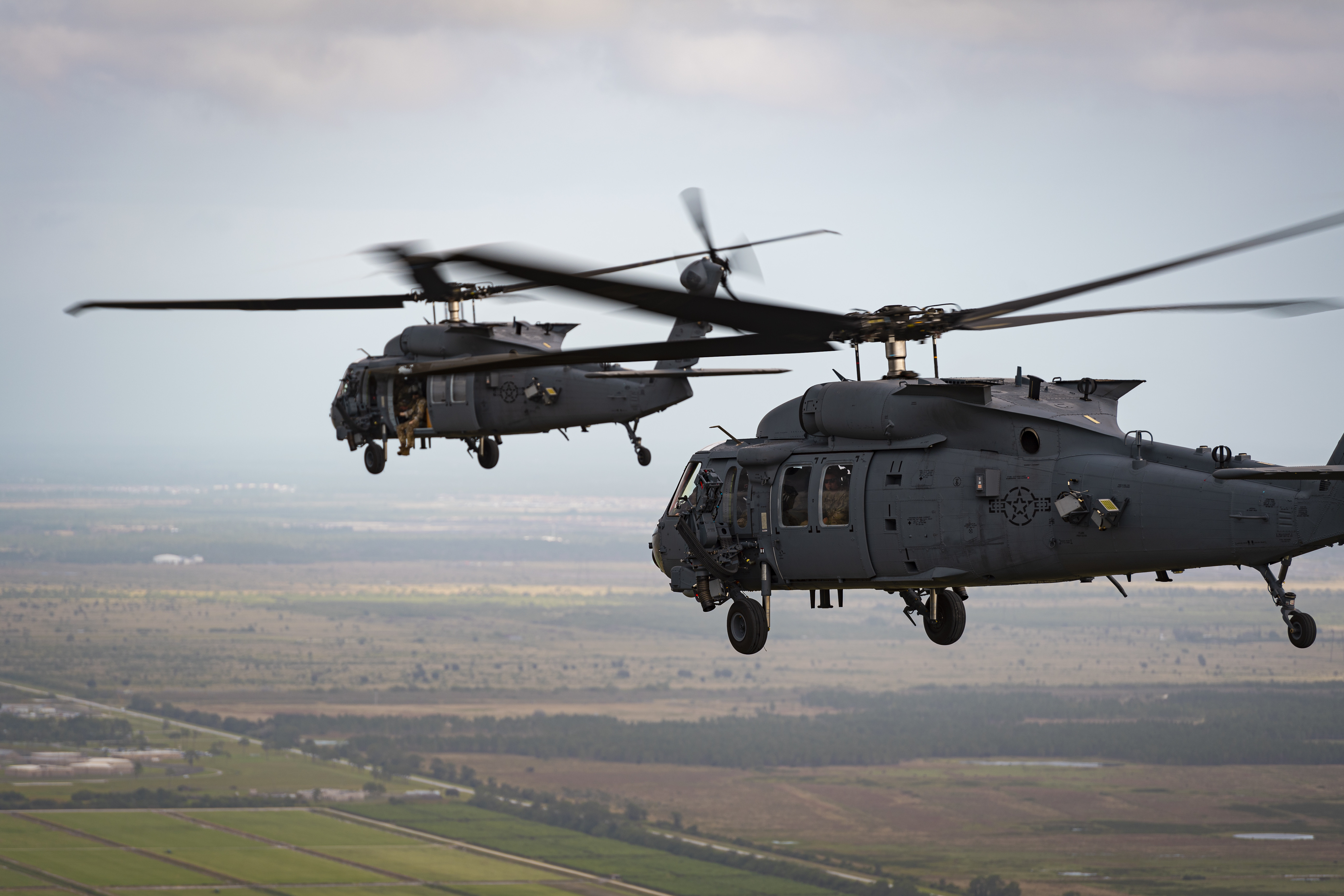 Two helicopters in flight.