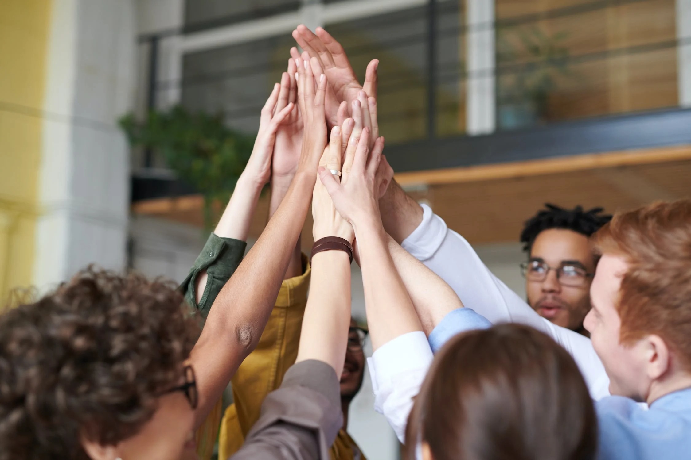 People putting their hands together in a gesture of teamwork