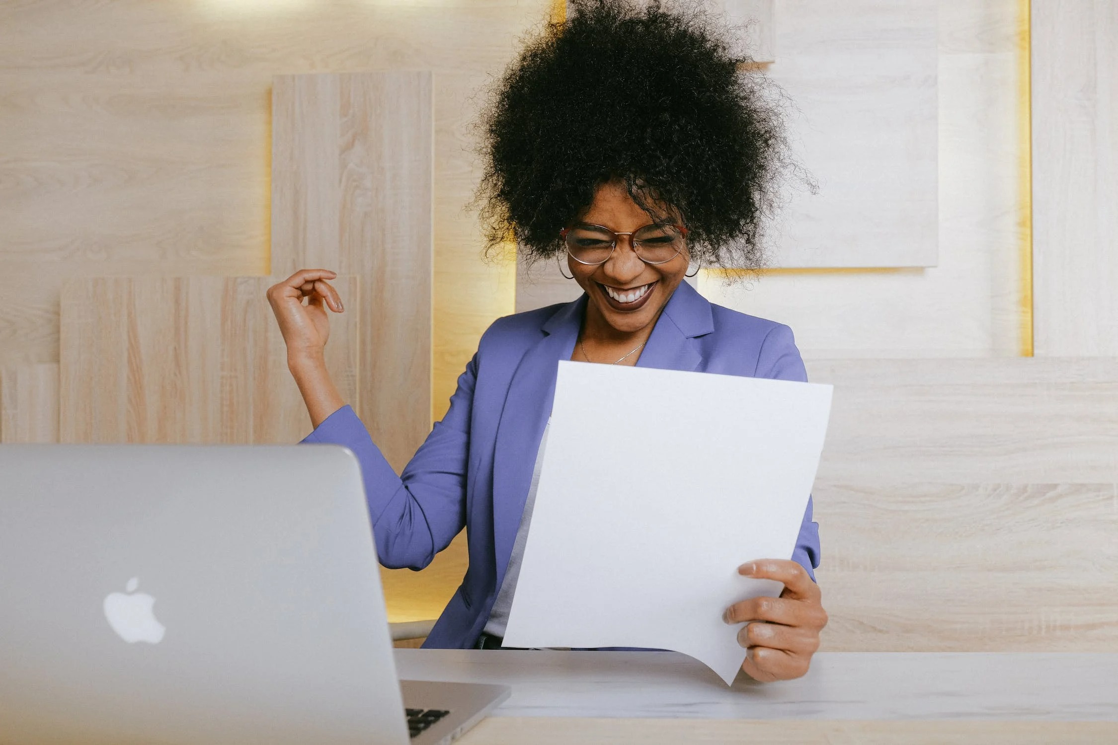 A woman smiling at a report